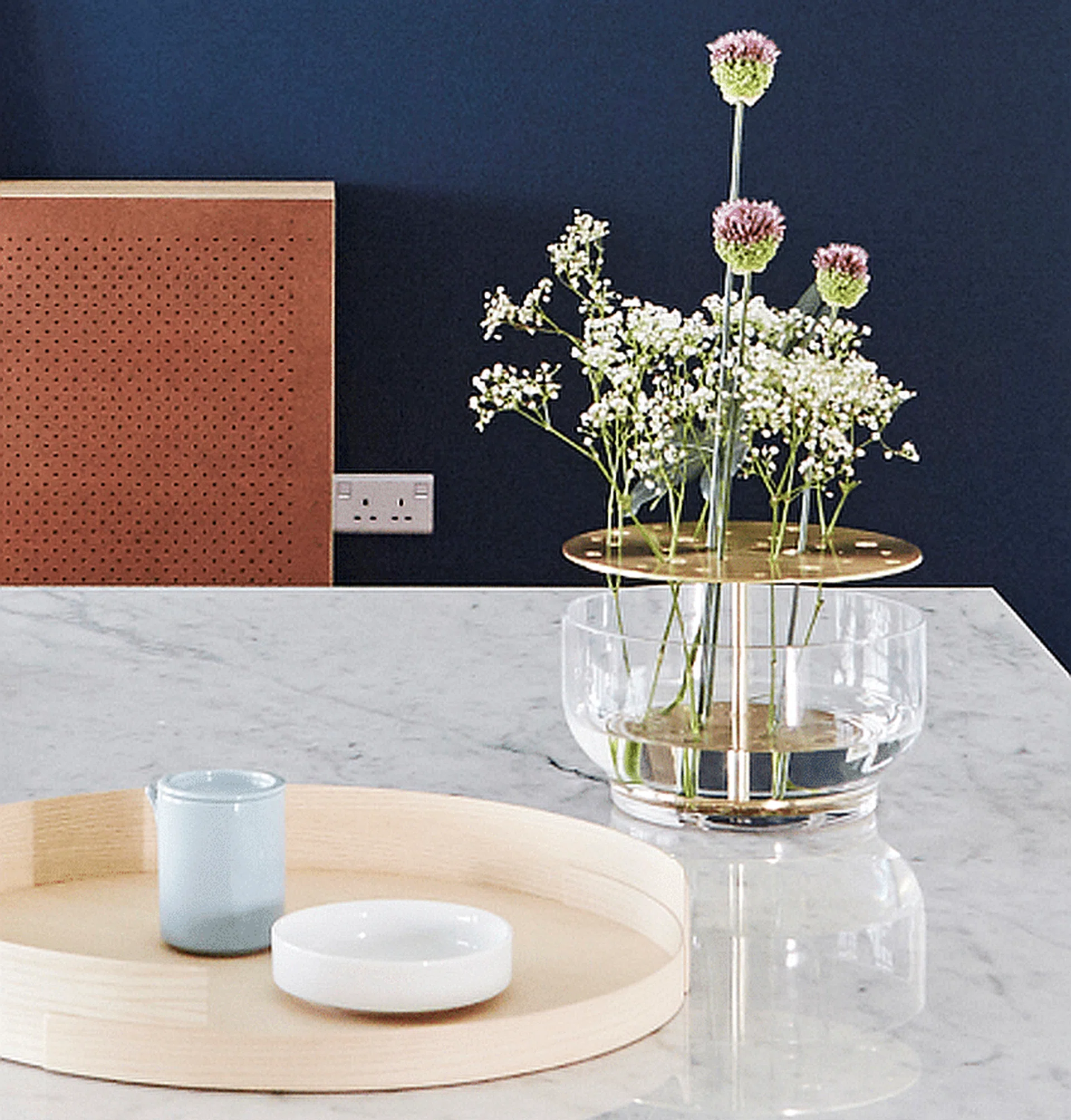 <h3>05: JAIME HAYON FOR FRITZ HANSEN</h3>
Inspired by ikebana, the Japanese art of arranging flowers, Spanish designer Jaime Hayon designed a glass-brass vase that accords every stalk enough space to be the centre of attention. The Ikebana vase is part of the functional yet playful Objects Collection by Fritz Hansen, which includes the elegant 1958 Folded Tray Table and handmade earthenware from Japan.