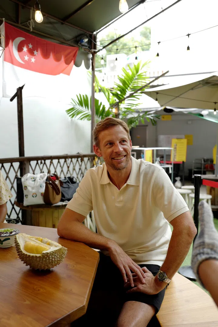 Jenson Button trying durian for the first time in Singapore. (Photo: Singapore Tourism Board)