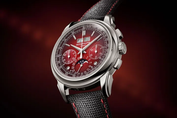 Patek Philippe Reference 5270P-017 perpetual calendar chronograph in platinum featuring a red lacquered dial that fades to black at the edges, white gold hands, moon-phase display, and a black strap with red stitching.