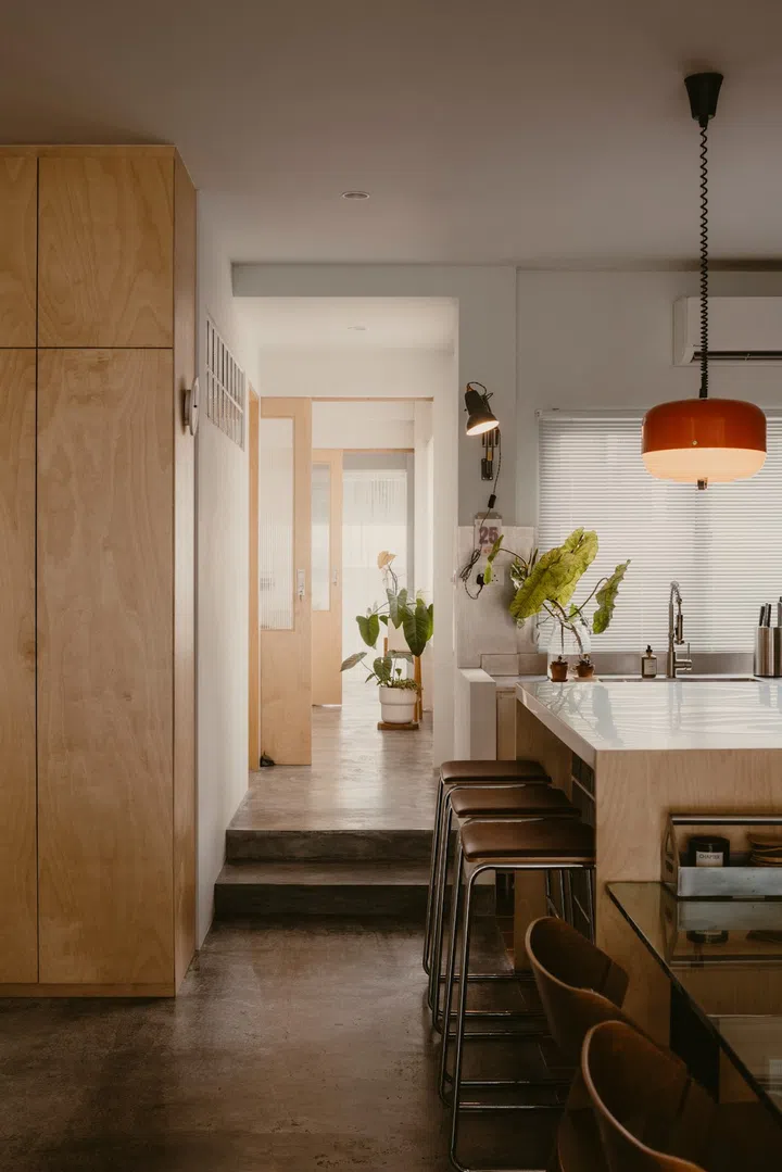 Beyond the common spaces is a room for the future ceramics workshop and a door that opens to the back terrace. (Photo: Studio Periphery)