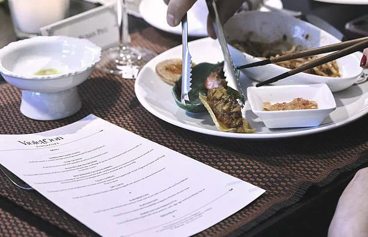 Violet Oon’s team serves dry laksa and other dishes to the guests.