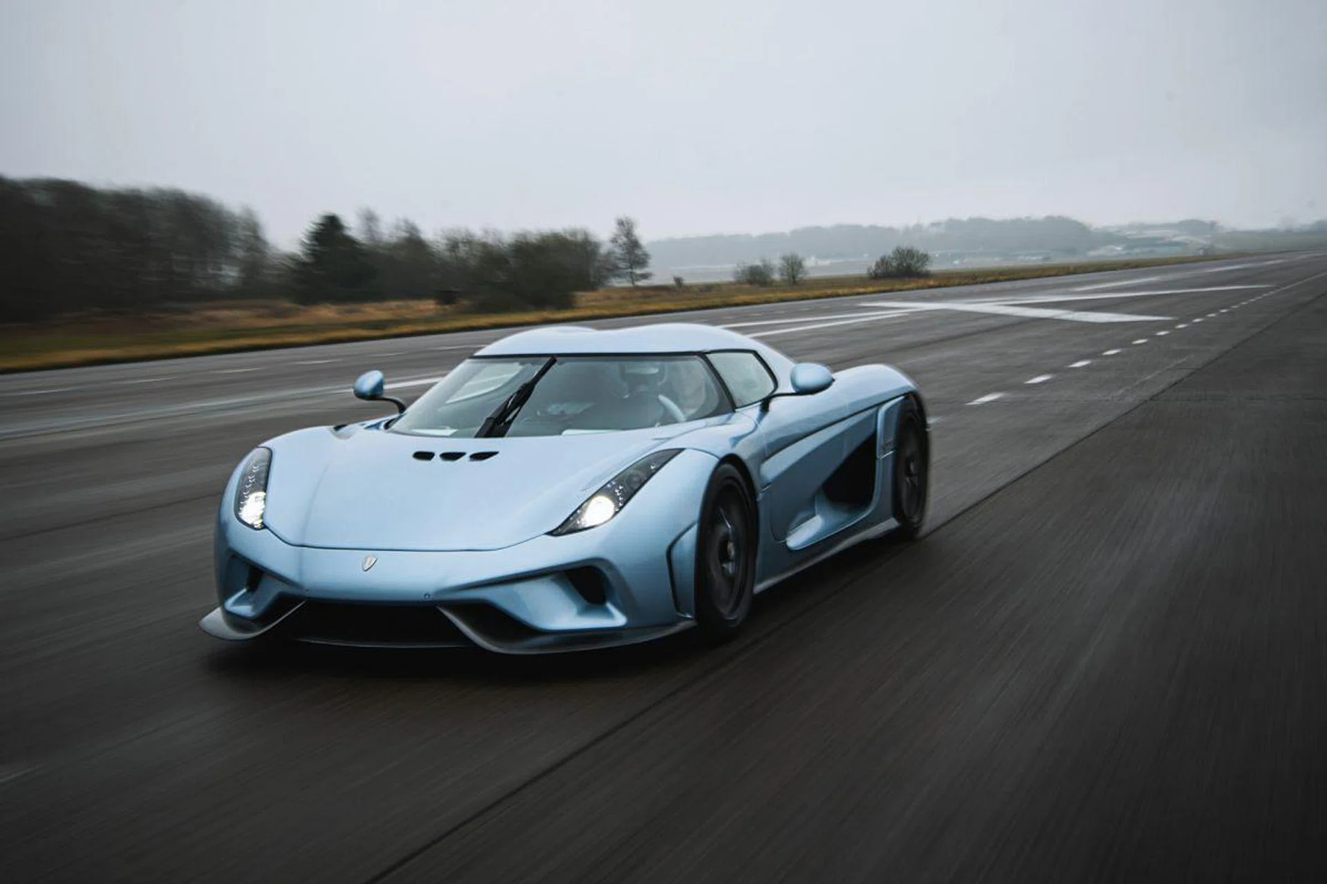 A Koenigsegg Regera is pictured on an old landing field of the ƒngelholm Airport, which is now rented by Koenigsegg, on November 26, 2019 in Angelholm, southern Sweden. - For a quarter century, Koenigsegg has been making supercars for a niche market typically reserved for Italian luxury brands, while challenging perceptions of Swedish modesty. In the Koenigsegg workshop in the southern town of Angelholm, the term "made in Sweden" is given a new meaning, and horsepower and torque take center stage. (Photo by Jonathan NACKSTRAND / AFP)