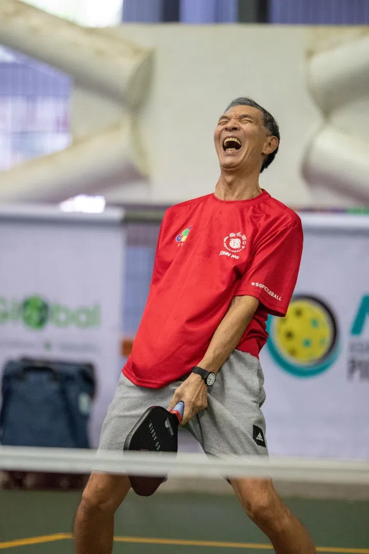 At 72, John Ng remains an active competitor and certified pickleball referee. He’s pictured mid-game at the Tampines North Pickleball Team Challenge 2021 (Photo credit: Singapore Pickle-ball Association)
