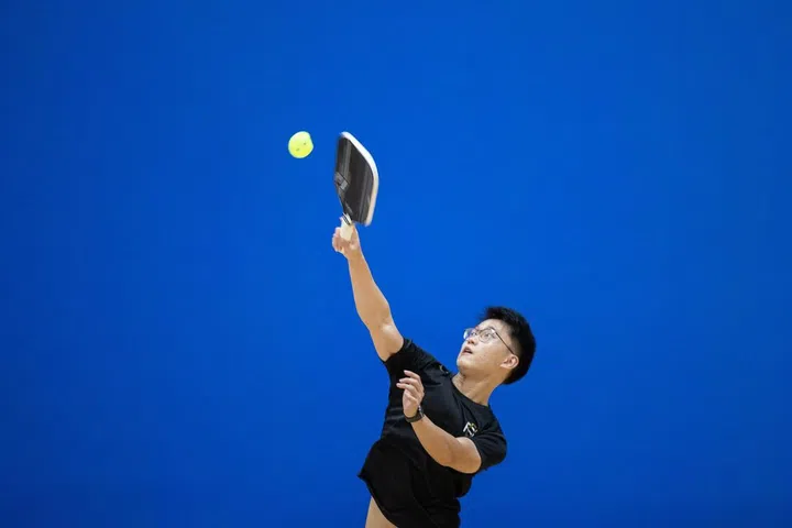 Darryl Kwok, a data scientist with Seagate Singapore, picked up Pickleball from his mum, and is a fan of world number 1 pickleball player Ben Johns. He sports his new Ben Johns paddle at the ActiveSG Year End Smash 2021. (Photo credit: Singapore Pickle-Ball Association) 