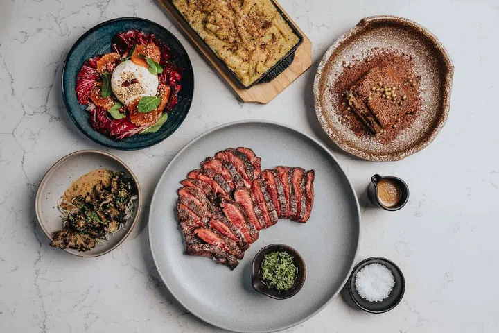 Flat iron steak with sides and dessert. Photo Meadesmoore