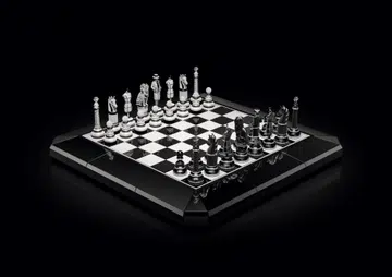 The Chanel Coco Game chessboard featuring black and white ceramic squares, diamond-set chess pieces inspired by Chanel motifs, and an obsidian base.