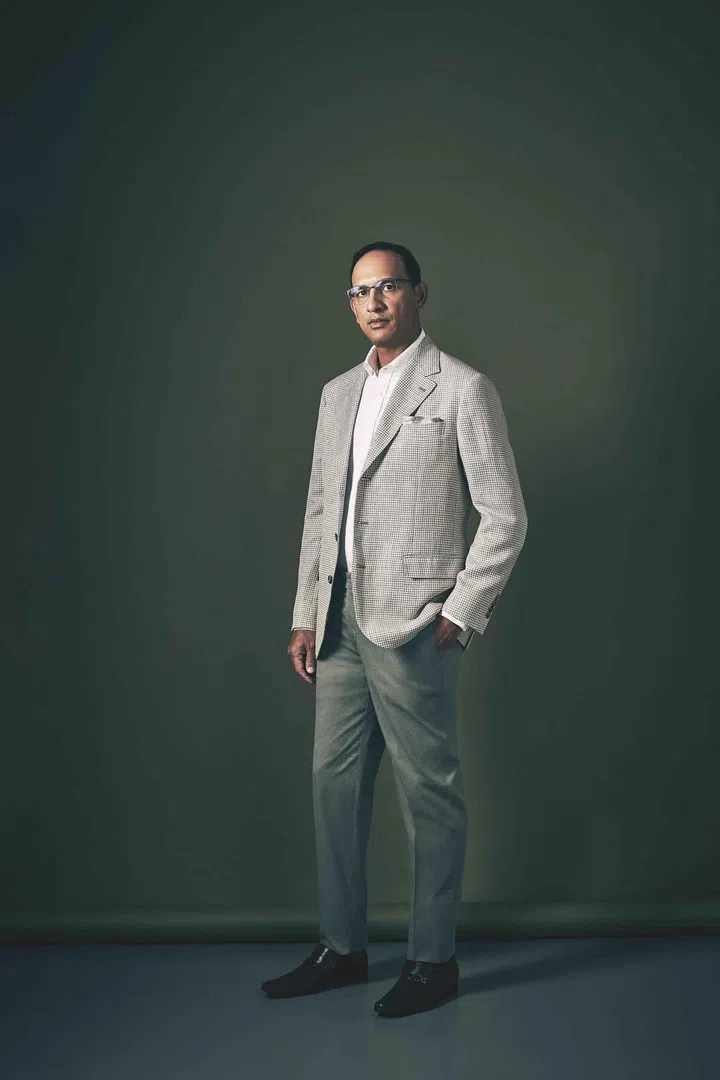 Rajeev is wearing a poplin shirt, cotton linen checkered jacket and cotton chino pants from Brunello Cucinelli.