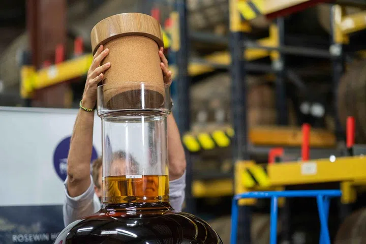 A full stretch for Daniel Monk, founder of The Intrepid, to seal in the 311 litres of 32 year old Macallan single malt. Photo: Fah Mai/Rosewin Holdings
