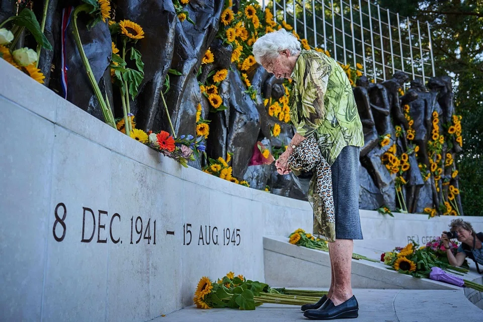 An ederly woman stands in front of the Indies monument on the day of the National Commemoration of the capitulation of Japan on 15 August 1945 in The Hague on 15 August 2024. (Phil Nijhuis/ANP/AFP)