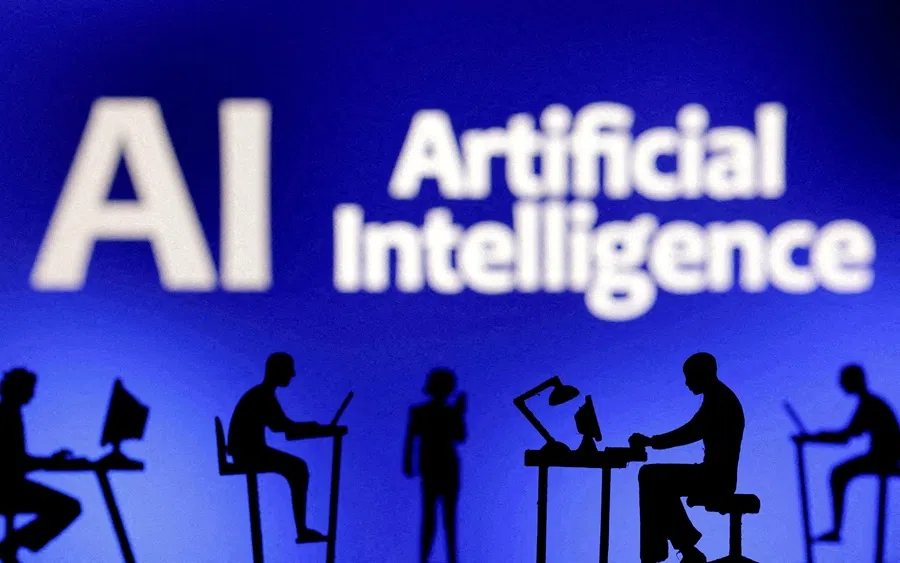 Figurines with computers and smartphones are seen in front of the words “Artificial Intelligence AI” in this illustration created on 19 February 2024. (Dado Ruvic/Illustration/Reuters)