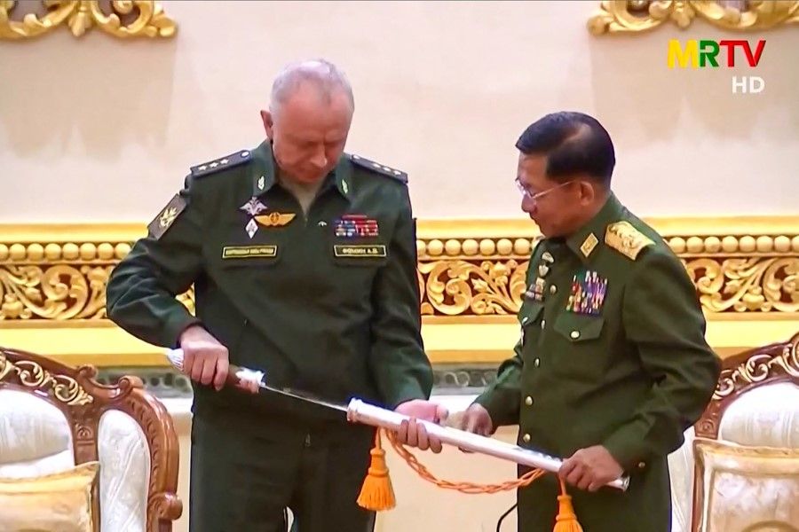 This screengrab provided via AFPTV and taken from a broadcast by Myanmar Radio and Television (MRTV) in Myanmar on 26 March 2021 shows Russia's Deputy Defence Minister Alexander Fomin (left) being presented with a sword by Myanmar armed forces chief Senior General Min Aung Hlaing in Naypyidaw. (Handout/AFP)