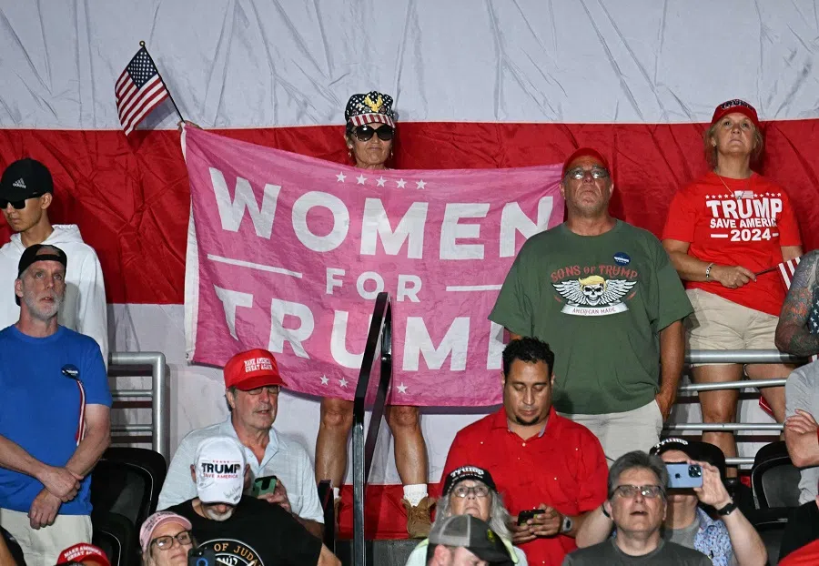 A supporter holds a “Women For Trump” banner as former US President and Republican presidential candidate Donald Trump speaks at a rally in Philadelphia, Pennsylvania, US on 22 June 2024. (Jim Watson/AFP)