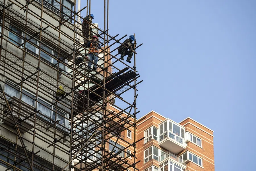 Workers stand on scaffolding in Shanghai, China, on 27 February 2022. (Qilai Shen/Bloomberg)