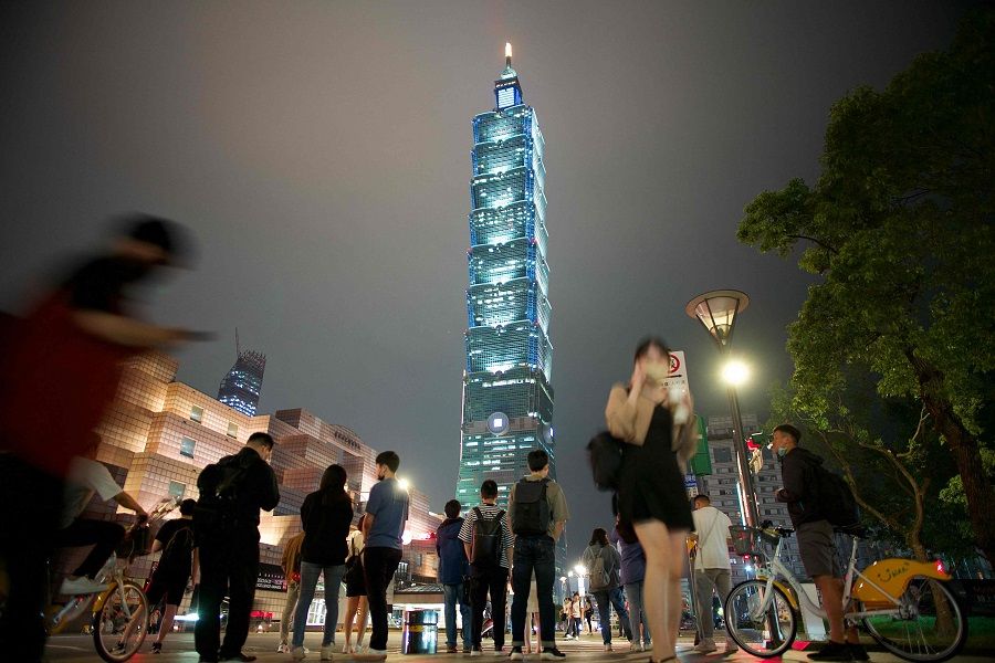 People walk past the Taipei 101 skyscraper in Taipei, Taiwan, on 28 April 2023. (Sam Yeh/AFP)
