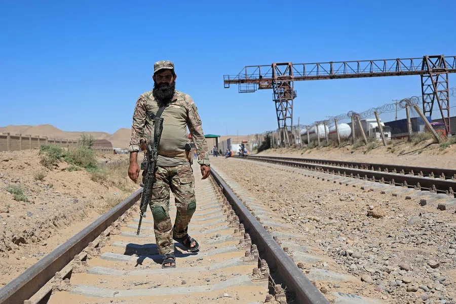 A Taliban security personnel walks at the construction site of railway tracks during the inauguration ceremony of the TAPI pipeline project, at the Turghundi border post near the zero point between Afghanistan and Turkmenistan, in Kushk district of Herat province on 11 September 2024. (Mohsen Karimi/AFP)