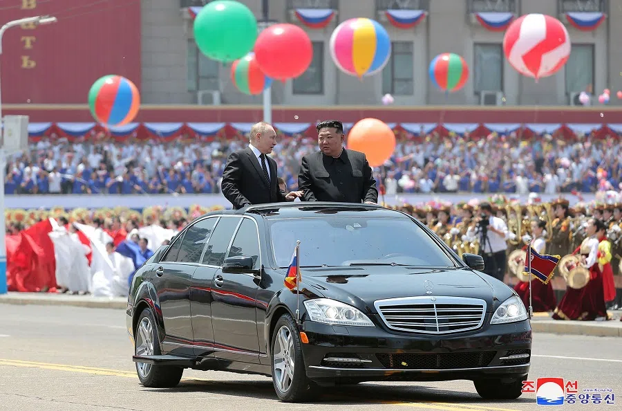 North Korea’s leader Kim Jong Un and Russia’s President Vladimir Putin parading around in an open-top car during a welcoming ceremony at Kim Il Sung Square in Pyongyang. Putin signed a mutual defence agreement on 19 June with North Korea’s Kim, who offered his “full support” on Ukraine.  (KCNA via KNS/AFP)