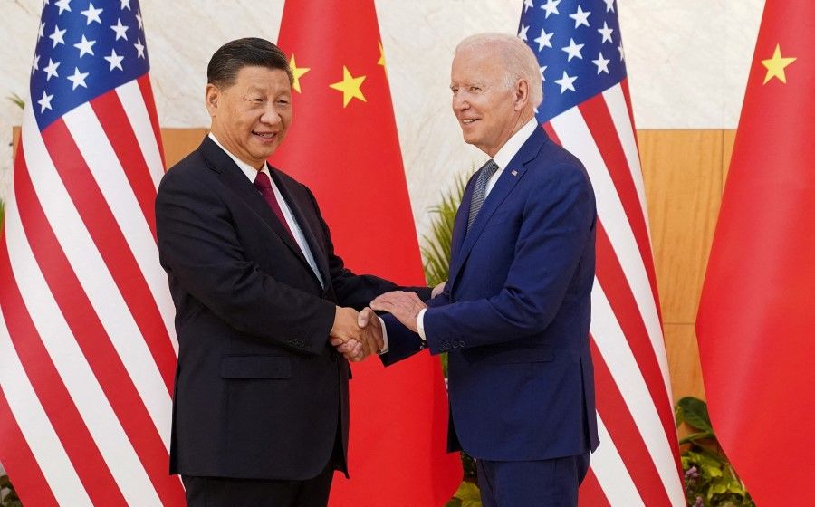 US President Joe Biden shakes hands with Chinese President Xi Jinping as they meet on the sidelines of the G20 leaders' summit in Bali, Indonesia, 14 November 2022. (Kevin Lamarque/Reuters)
