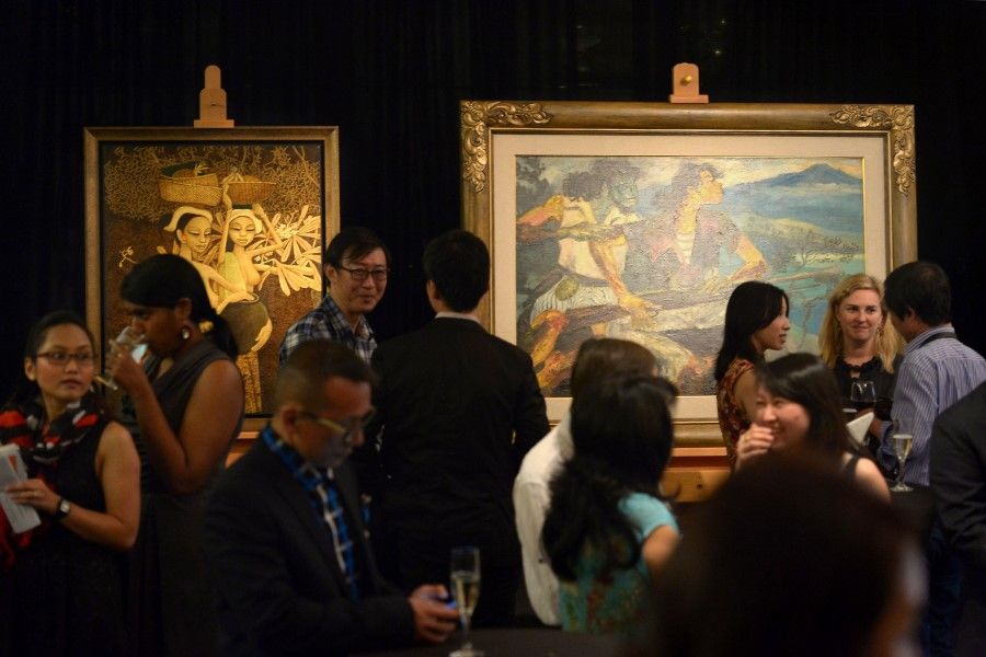 Visitors mingle amid artworks such as Cheong Soo Pieng's Returning From Market (background, far left) at the National Gallery Singapore's National Collection, Singapore, 2014. (SPH Media)