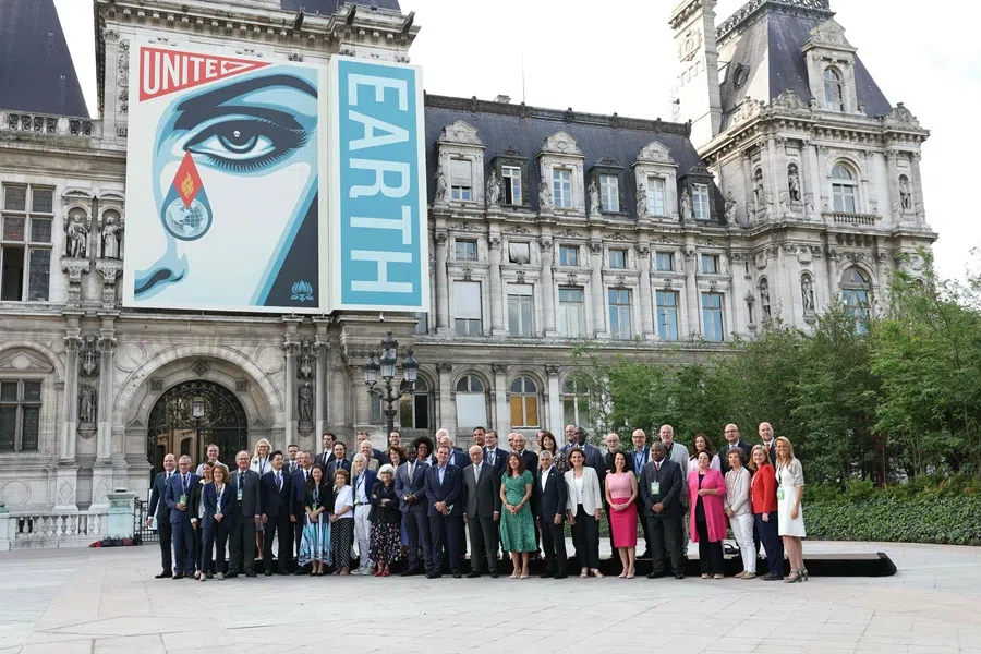 Mayor of Paris Anne Hidalgo poses with attendees for a group photograph prior to a Mayors’ summit to mark ten years of the Paris Agreement, outside the City Hall of Paris on 23 June 2025. (Thomas Samson/AFP)