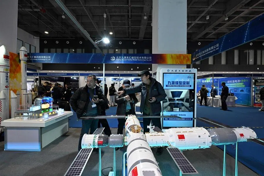 People visit the 2026 Beijing International Commercial Space Exhibition in Beijing on 23 January 2026. (Adek Berry/AFP)