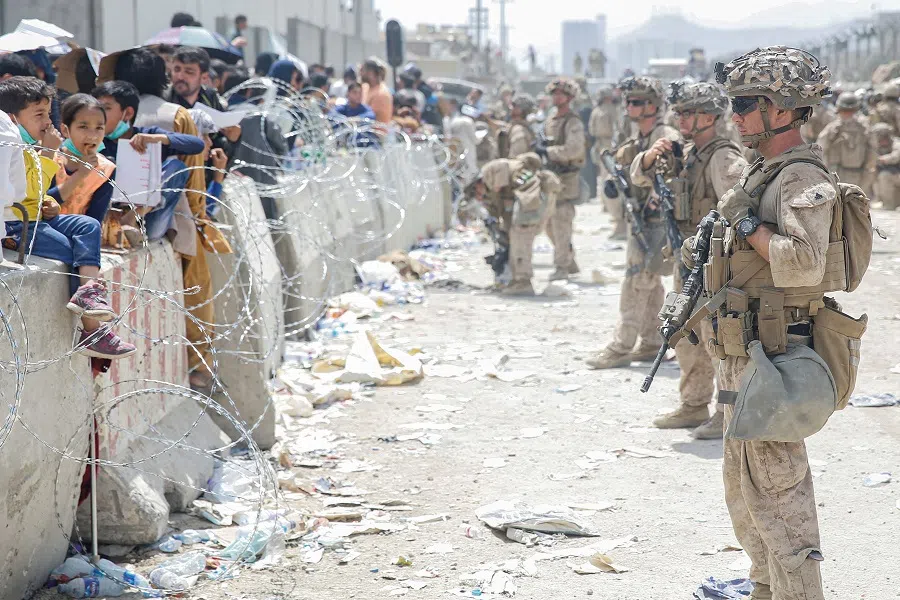 US Marines provide assistance during an evacuation at Hamid Karzai International Airport, in Kabul, Afghanistan, 20 August 2021. (Lance Cpl. Nicholas Guevara/US Marine Corps via Reuters/File Photo)