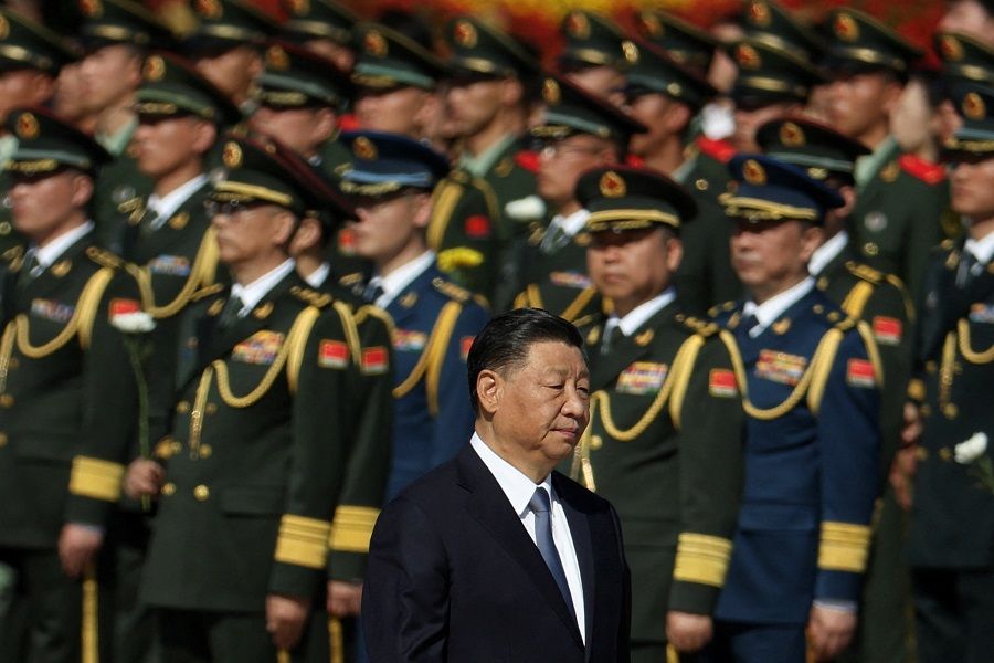 Chinese President Xi Jinping walks past members of the Chinese People's Liberation Army as he arrives for a ceremony in Beijing, China, 30 September 2023. (Florence Lo/Reuters)