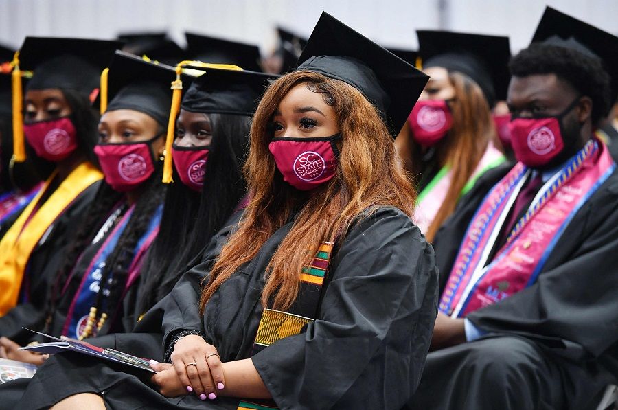 Students attend their graduation ceremony at South Carolina State University on 17 December 2021, in Orangeburg, South Carolina, US. (Mandel Ngan/AFP)