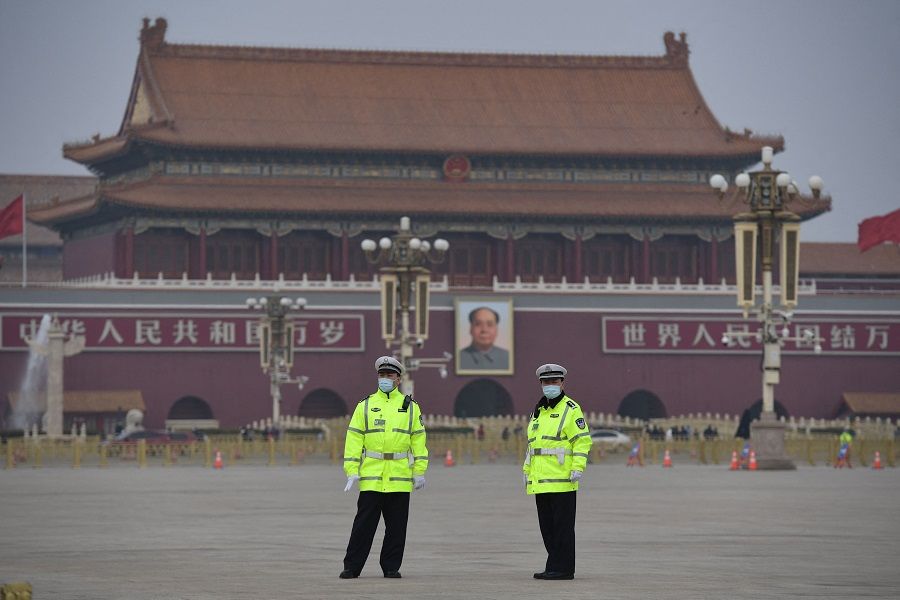 Police officers keep watch at Tiananmen Square ahead of the closing session of the National People's Congress in Beijing, China on 11 March 2021. (Nicolas Asfouri/AFP)