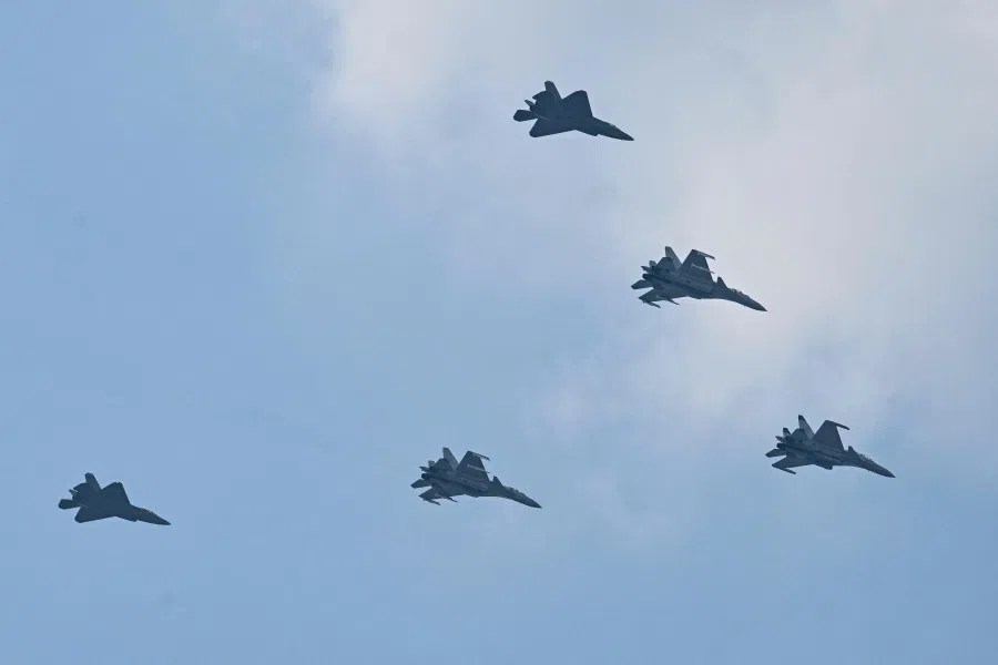Shenyang J-15 (lead and middle aircraft) and Shenyang J-35 (back) jet fighters perform a flyby during a military parade marking the 80th anniversary of victory over Japan and the end of World War II, in Beijing’s Tiananmen Square on 3 September 2025. (Hector Retamal/AFP)