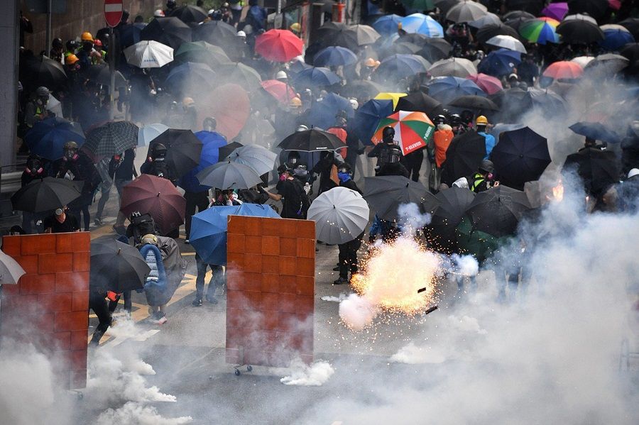 A tear gas canister explodes as protesters retreat near Lippo Centre, Hong Kong, on 29 September 2019. (SPH Media)