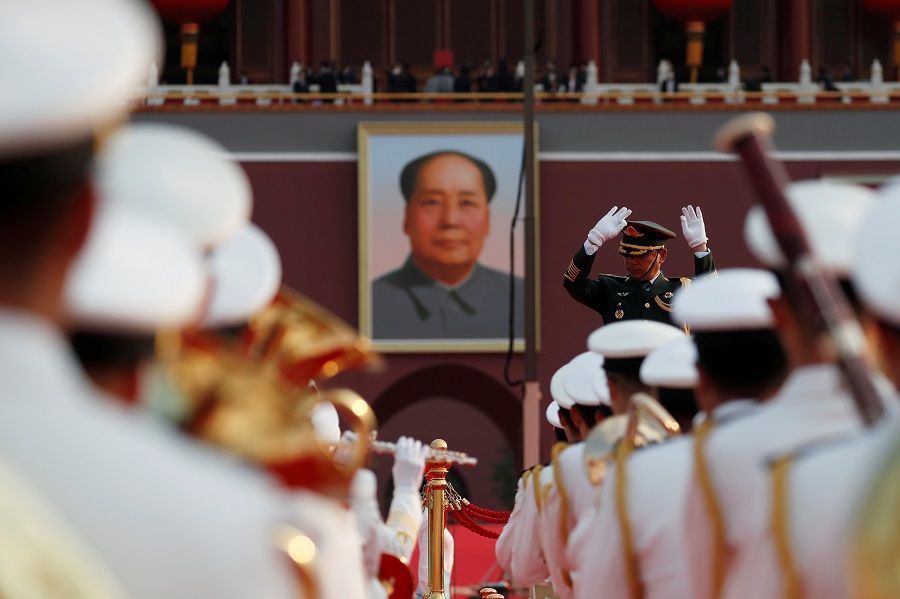 Military band members practice before the event marking the 100th founding anniversary of the Communist Party of China, in front of a portrait of late Chinese chairman Mao Zedong on Tiananmen Square in Beijing, China, 1 July 2021. (Carlos Garcia Rawlins/Reuters)