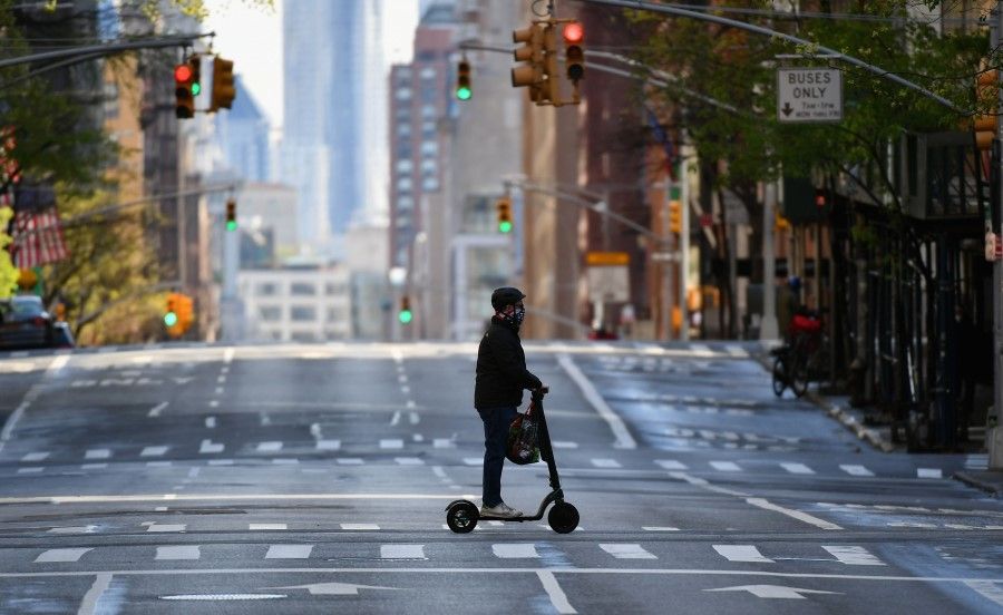 A person rides a scooter on April 21, 2020 in New York City. (Angela Weiss/AFP)