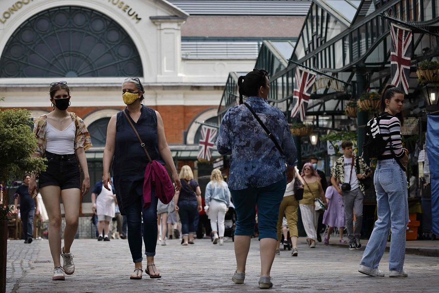 People walk through Covent Garden in London on 3 June 2021. (Tolga Akmen/AFP)