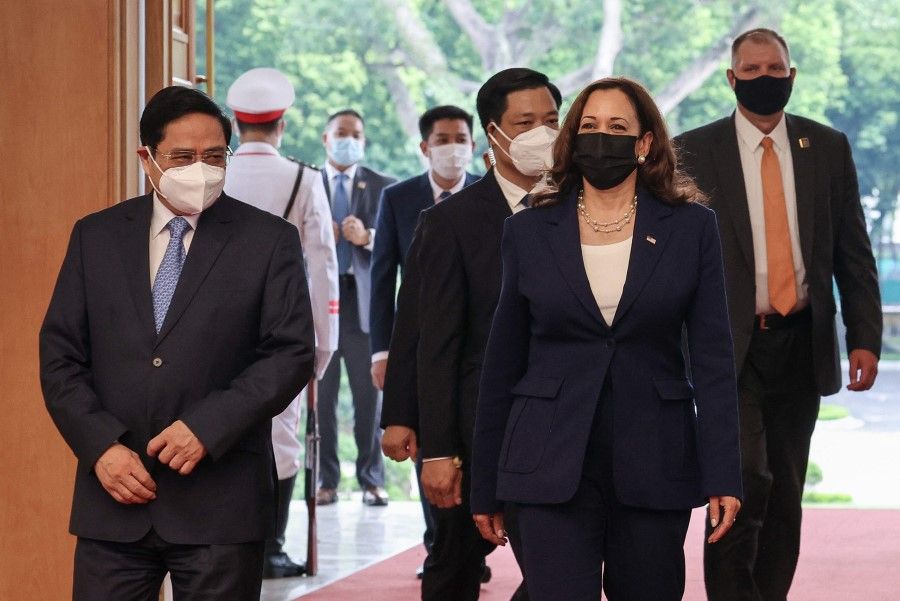 US Vice President Kamala Harris walks with Vietnam's Prime Minister Pham Minh Chinh at the Office of Government, in Hanoi, Vietnam, 25 August 2021. (Evelyn Hockstein/AFP)