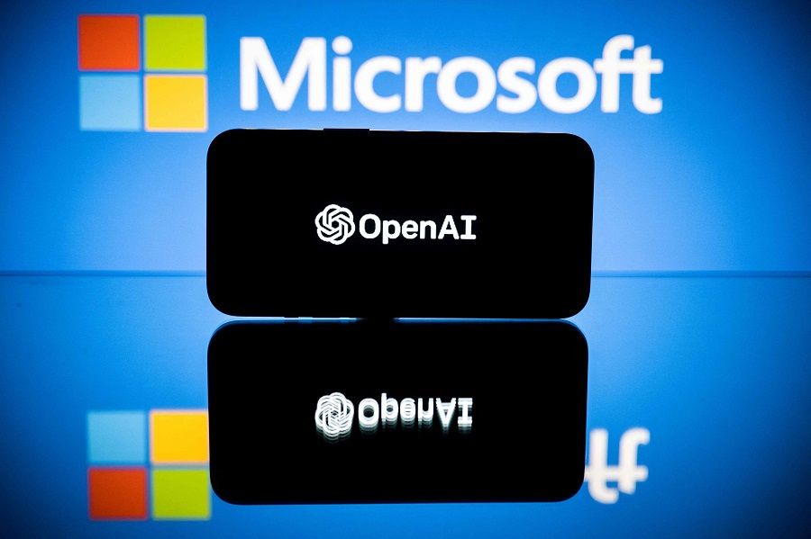 This picture taken on 23 January 2023 in Toulouse, France, shows screens displaying the logos of Microsoft and OpenAI. (Lionel Bonaventure/AFP)