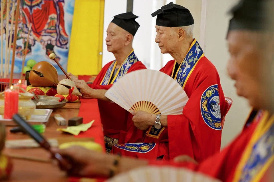 Woo Ying Poh (centre) is one of Singapore’s last few Cantonese Taoist funeral priests who still knows how to perform the “Breaking Hell’s Gate” ritual.