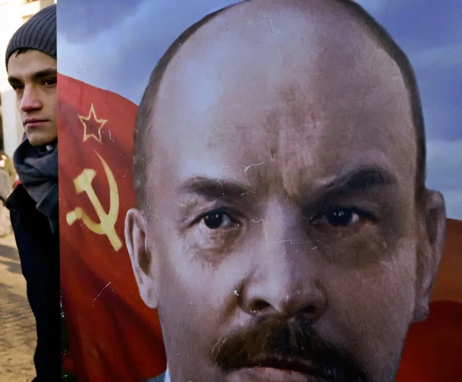A Russian communist supporter holds a portrait of former Soviet leader Vladimir Lenin, before a flower-laying ceremony at the mausoleum of the founder of the Soviet state, Vladimir Lenin, to mark the 100th anniversary of his death, in Moscow on 21 January 2024. (Alexander Nemenov/AFP)