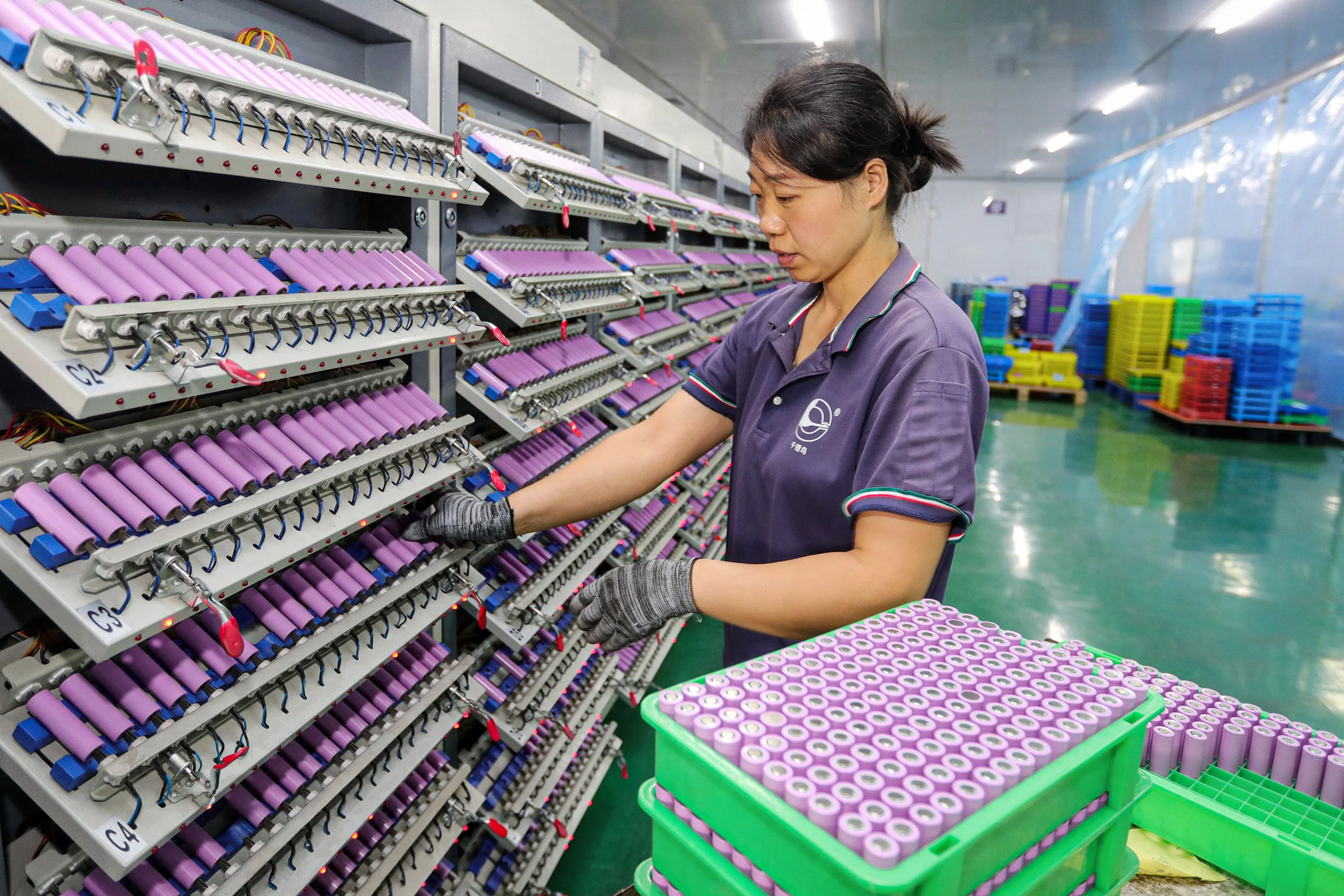 An employee works at a company manufacturing lithium batteries in Huaibei, in eastern China’s Anhui province on 26 November 2024.