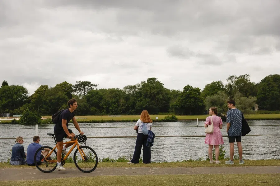 People along the banks of the River Thames in Henley-on-Thames, UK, on 23 June 2024.  (Vivian Wan/Bloomberg)