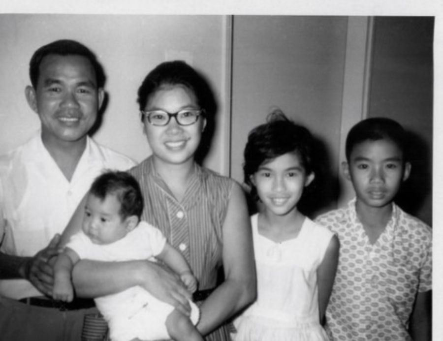 Augusta carrying David, their new addition to the family, with Catherine and Frederick beside her, Singapore, 1962.