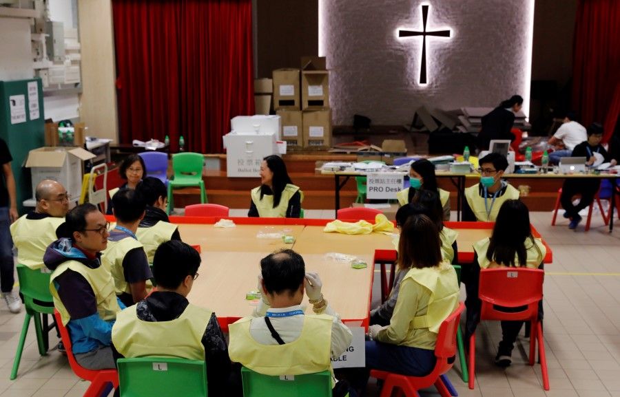 Polling officials prepare to count the votes of the Hong Kong council elections. (Adnan Abidi/REUTERS)