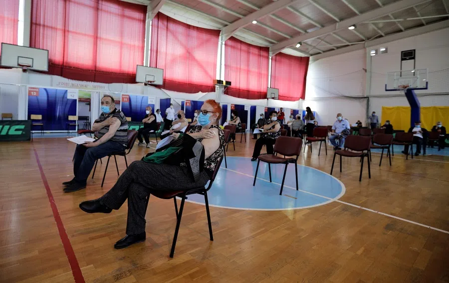 People rest after receiving a dose of China's Sinopharm Covid-19 vaccine at a sport centre, in Stip, North Macedonia, 6 May 2021. (Ognen Teofilovski/Reuters)