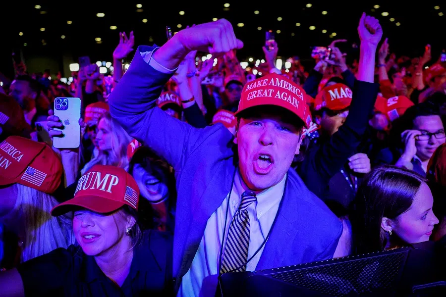 Supporters of Republican presidential nominee and former US President Donald Trump celebrate after the Fox Network called the election in his favour at the site of his rally, at the Palm Beach County Convention Center in West Palm Beach, Florida, US, on 6 November 2024. (Brian Snyder/Reuters)
