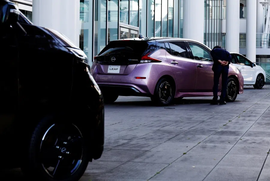 A visitor looks at Nissan Motor's electric vehicle (EV) model Leaf at its showroom in Yokohama, Japan, on 3 November 2023. (Kim Kyung-Hoon/Reuters)