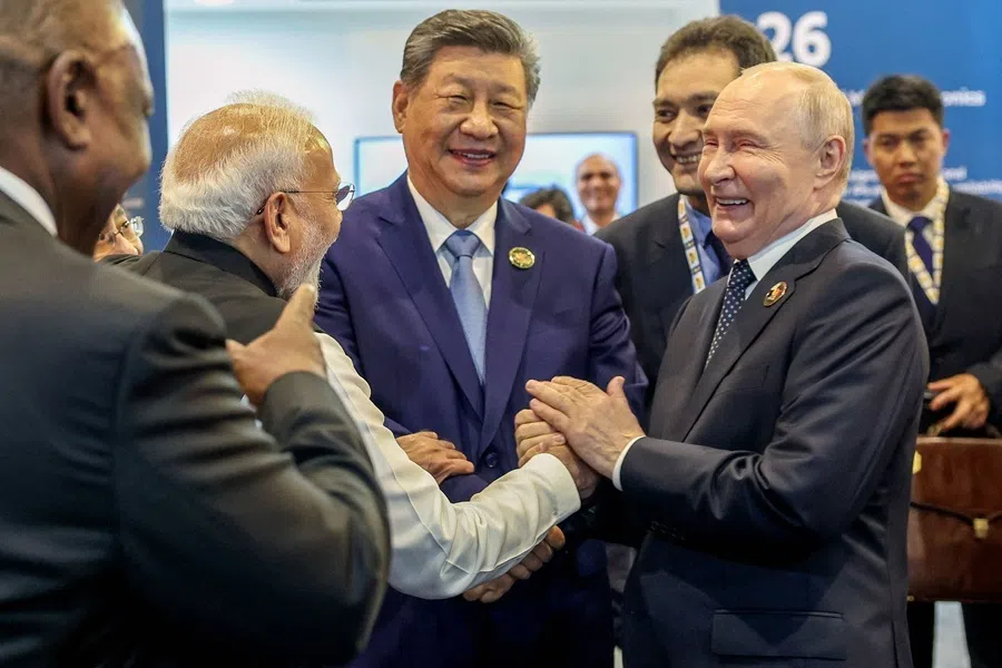 This handout photograph taken on 12 September 2026 and released by India's Ministry of External Affairs (MEA) shows India's Prime Minister Narendra Modi (second from left), China's President Xi Jinping (centre) and Russia's President Vladimir Putin (right) sharing a light moment during the 18th BRICS Summit in New Delhi.