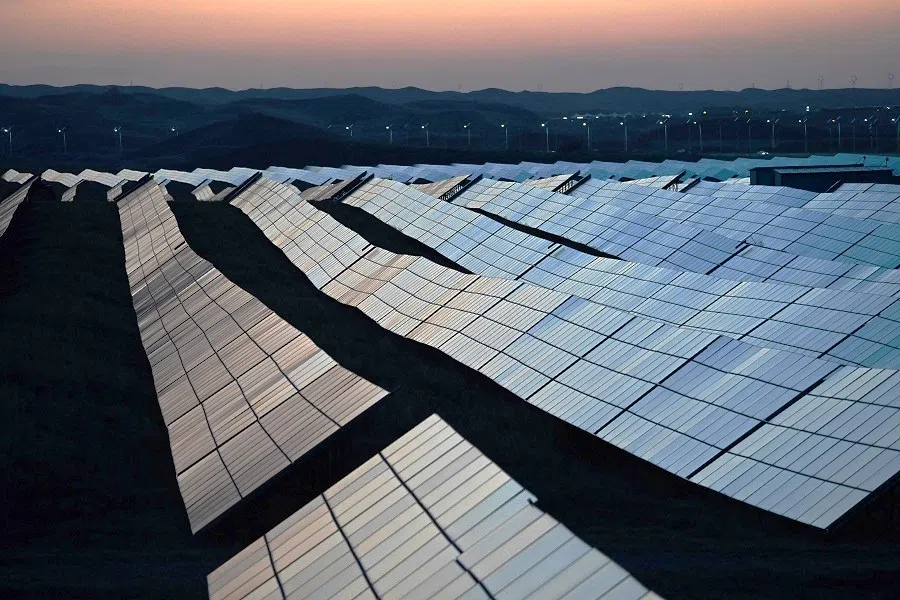 Solar panels are seen at dusk in the Tengger Desert Solar Park in Ningxia Hui Autonomous Region, China, on 21 August 2024.