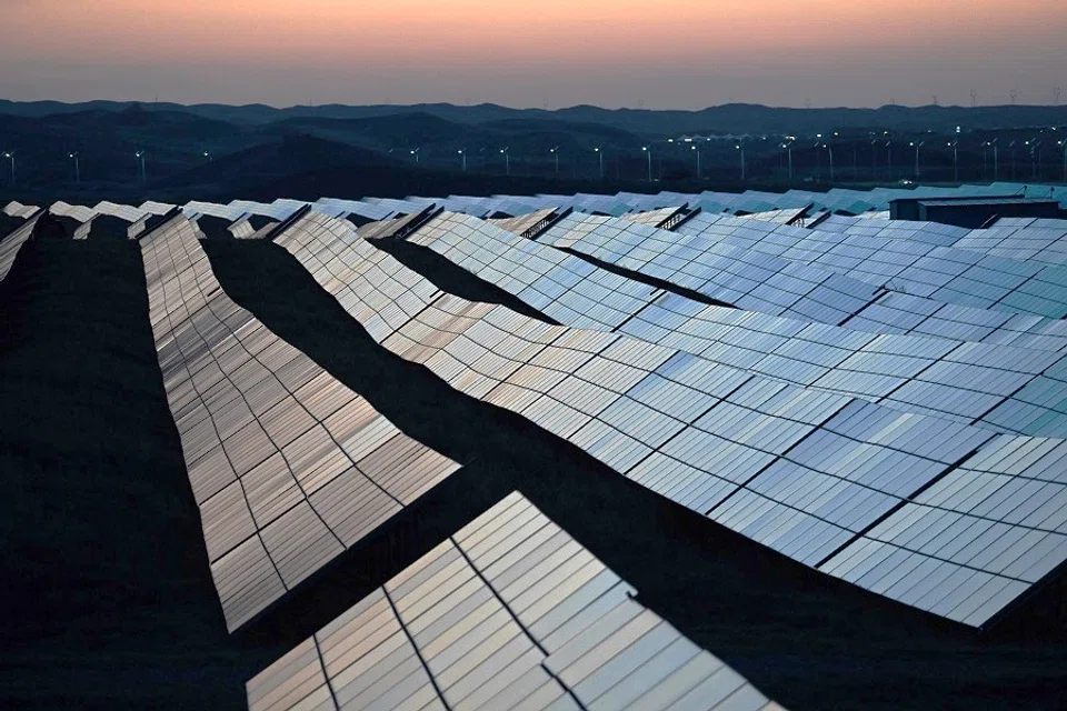 Solar panels are seen at dusk in the Tengger Desert Solar Park in Ningxia Hui Autonomous Region, China, on 21 August 2024. (Greg Baker/AFP)