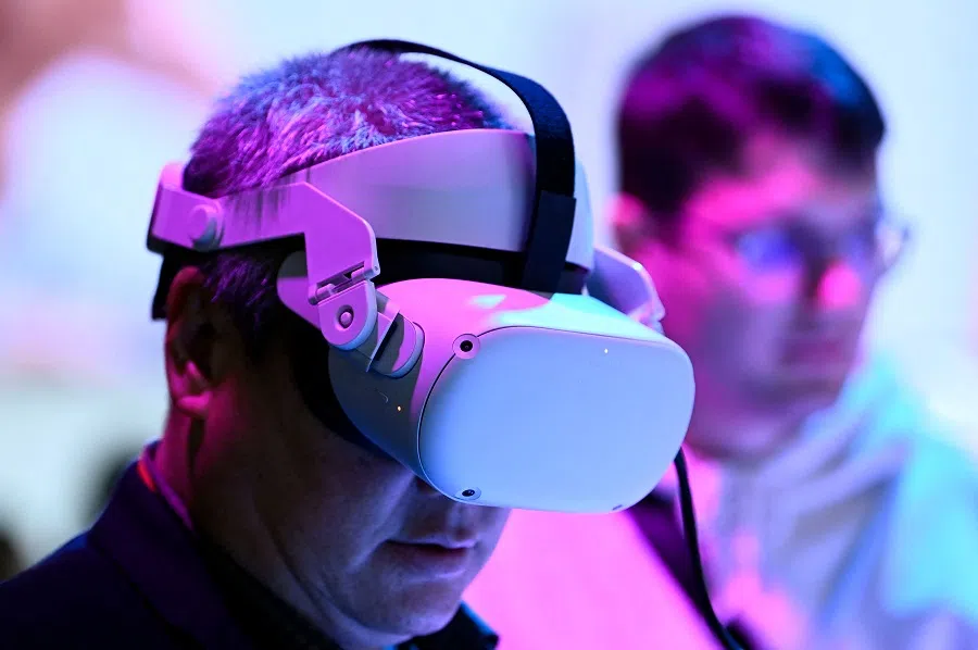 A person tries an Oculus Meta Quest virtual reality headset at the Mobile World Congress, in Barcelona, Spain, on 28 February 2023. (Josep Lago/AFP)