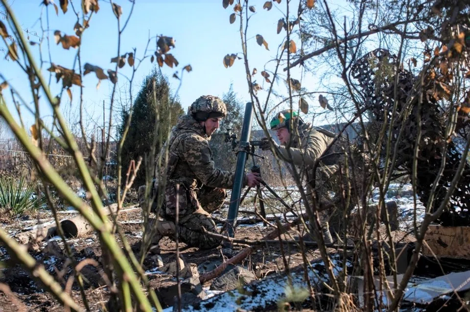 Ukrainian service members prepare a mortar to fire toward Russian troops in the frontline town of Bakhmut, amid Russia's attack on Ukraine, in Donetsk region, Ukraine, in this handout picture released 13 February 2023. (Iryna Rybakova/Press Service of the 93rd Independent Kholodnyi Yar Mechanized Brigade of the Ukrainian Armed Forces/Handout via Reuters)