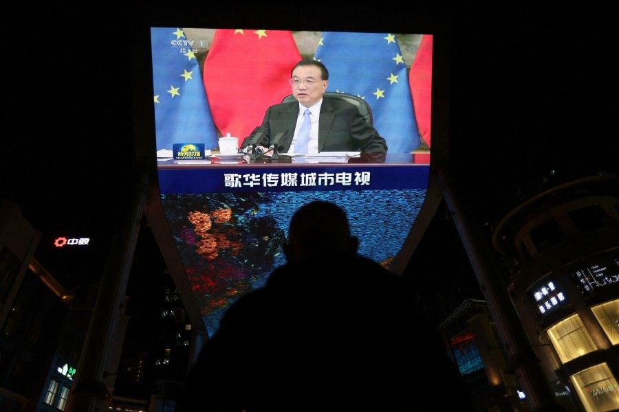 A giant screen shows news footage of Chinese Premier Li Keqiang in Beijing, China, 1 April 2022. (Tingshu Wang/Reuters)